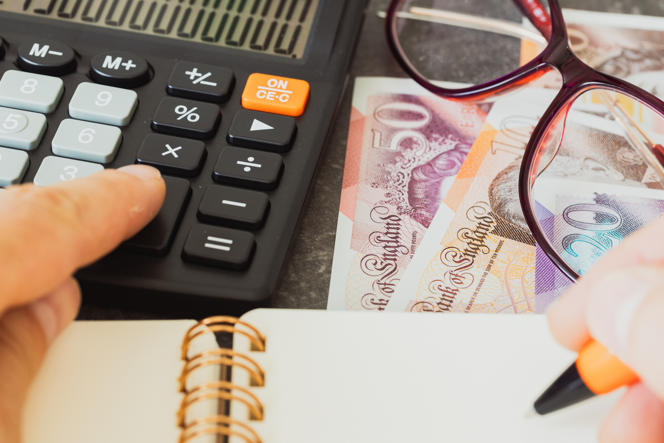 Financial settlements in Britain Pounds, Financial analysis, Tax calculation, Risk costs, business project. UK money, close up.